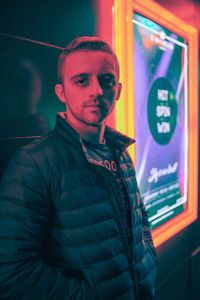 Portrait of young man looking away at night