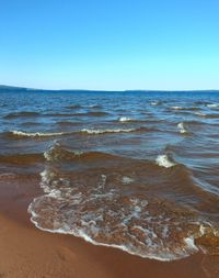 Scenic view of sea against clear blue sky