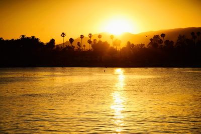 Scenic view of lake against sky during sunset