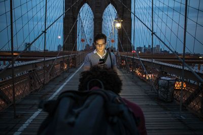 Man sitting on footbridge