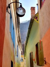 Low angle view of street light against building