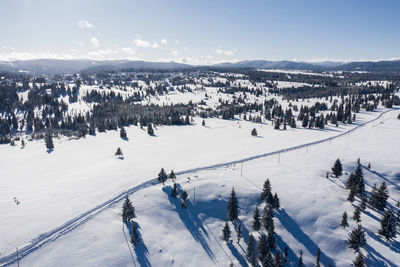 Aerial drone view of snow covered winter landscape in the mountains