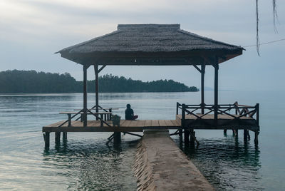 Woman sitting under shelter on kadidi island in north sulawesi
