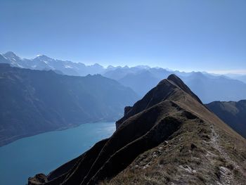 Scenic view of snowcapped mountains against clear blue sky