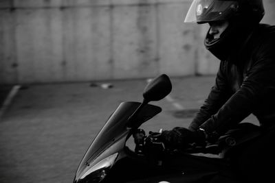 Young man riding motorcycle on road