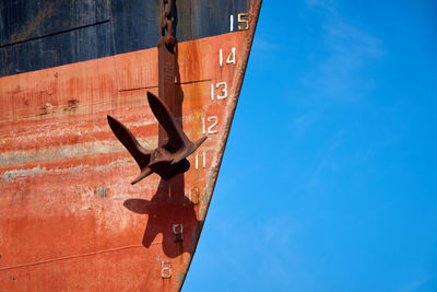 Low angle view of a ship against blue sky