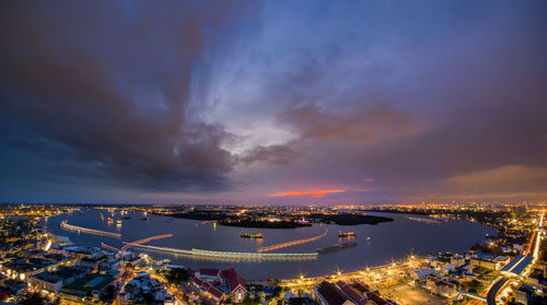 High angle view of illuminated city against sky at night