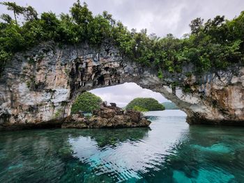 Scenic view of sea against sky stone arch