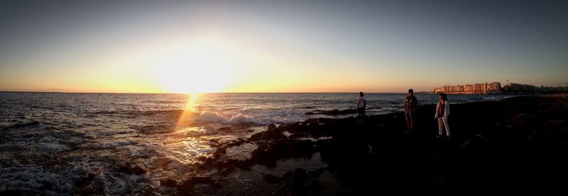 Scenic view of sea against clear sky during sunset