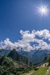 Scenic view of mountains against blue sky