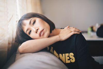 Portrait of woman siting on sofa at home