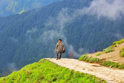 Rear view of man standing on mountain