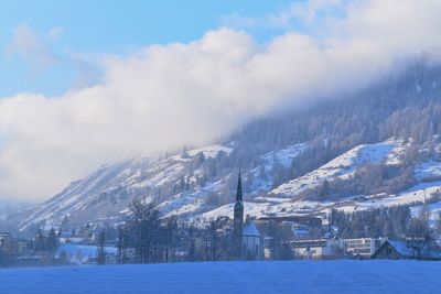 Scenic view of snow covered mountains against sky