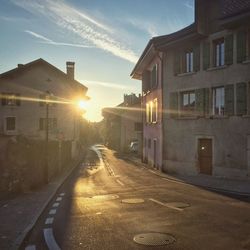 Street amidst houses against sky at night