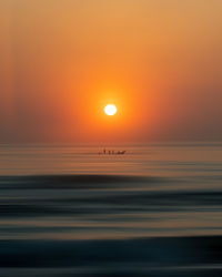 Scenic view of sea against romantic sky at sunset