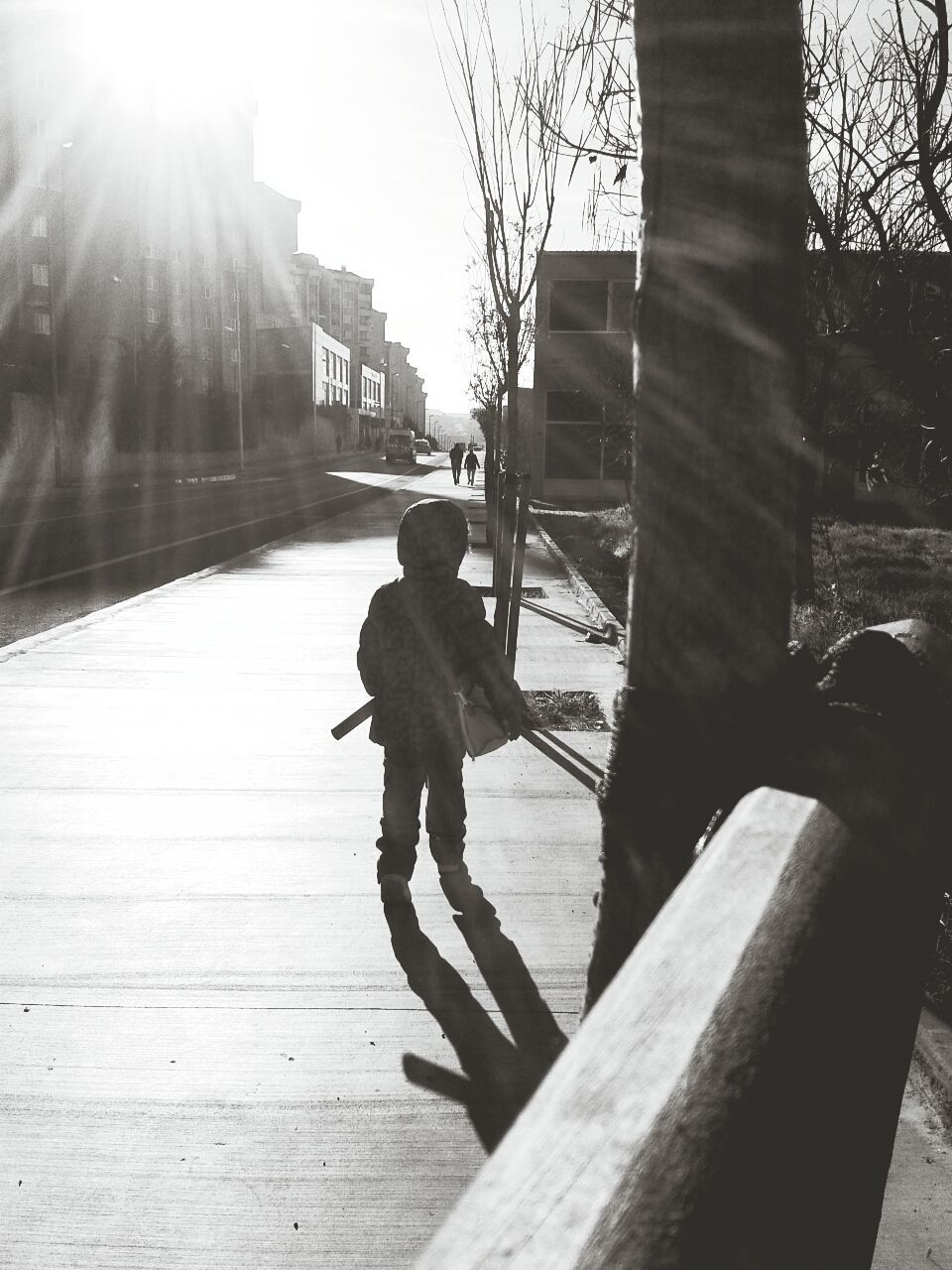 lifestyles, full length, sunlight, leisure activity, built structure, casual clothing, railing, clear sky, architecture, men, bicycle, standing, rear view, transportation, shadow, walking, sun, building exterior