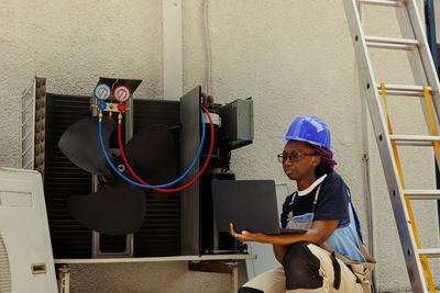 Side view of man working at construction site