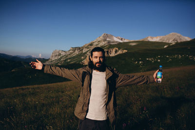 Full length of man standing on mountain against sky