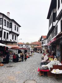 Street market against buildings in city