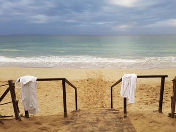 Rear view of man on beach against sky