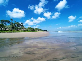 Scenic view of beach against blue sky