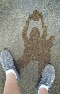 Low section of man standing on road