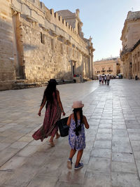 Rear view of woman walking on street