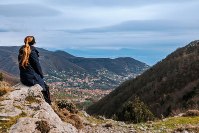 Portrait of man standing on mountain against sky
