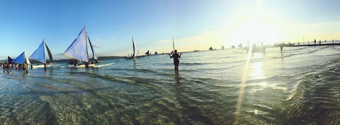 Sailboats sailing on sea against sky