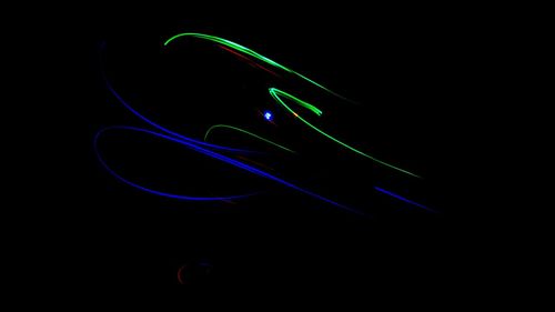 Close-up of light painting against black background