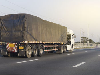 Vehicles on road against sky