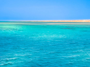 Scenic view of sea against clear blue sky