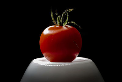 Close-up of strawberry over black background