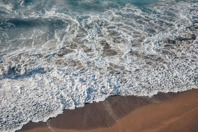 High angle view of surf on beach