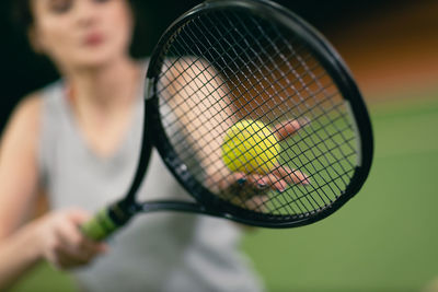 Midsection of man playing tennis