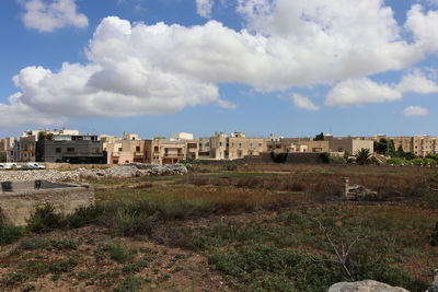 Old buildings in city against sky