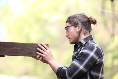 Side view of young man looking away