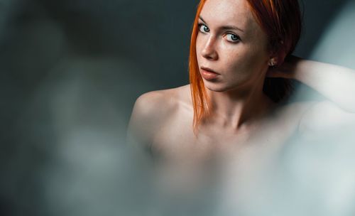 Portrait of naked young redhead woman