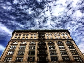 Low angle view of building against cloudy sky