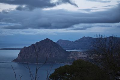 Scenic view of sea and mountains against sky