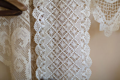 View of laces hanging against wall at home