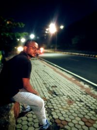 Side view of man standing at night