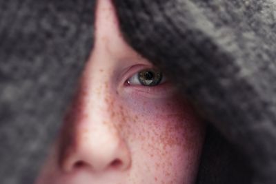 Close-up portrait of boy with freckles on face