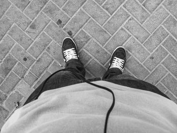 Low section of man standing on ground