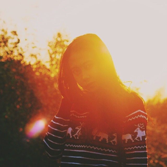 sunset, sky, close-up, focus on foreground, orange color, lens flare, spirituality, art and craft, sun, art, human representation, outdoors, no people, religion, creativity, low angle view, sunlight, sculpture