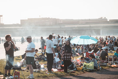 Group of people in city against sky