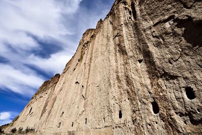 Low angle view of rock formation against sky