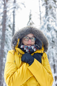 Portrait of young woman wearing warm clothing standing outdoors