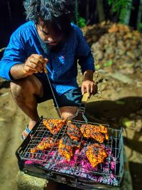 Man preparing food on barbecue grill