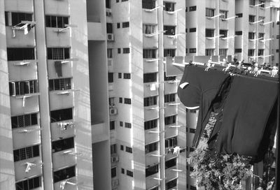 Clothesline hanging by buildings on sunny day